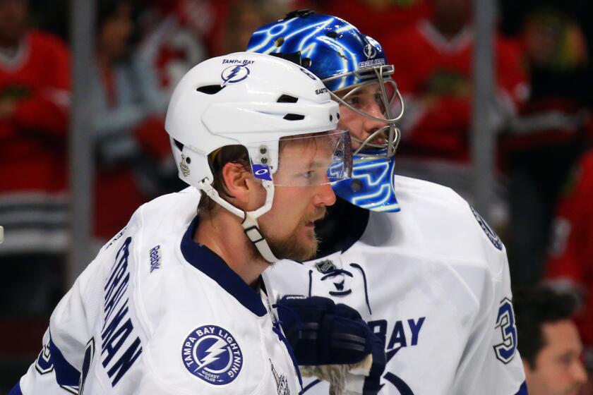 Tampa Bay goalie Ben Bishop celebrates the Lightning's 3-2 victory over the Chicago Blackhawks with teammate Anton Stralman after Game 3 of the Stanley Cup Final.