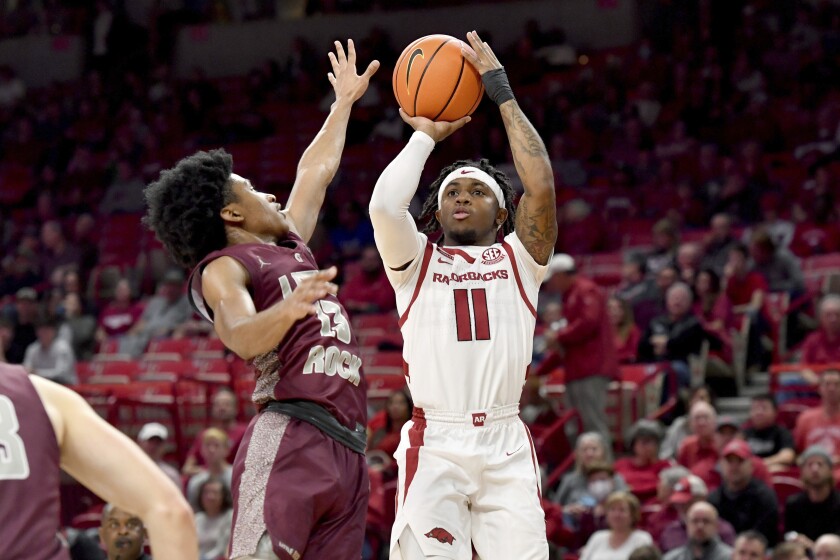 Arkansas guard Chris Lykes (11). Shoots over Arkansas-Little Rock guard D.J. Smith (13) during the first half of an NCAA college basketball game Saturday, Dec. 4, 2021, in Fayetteville, Ark. (AP Photo/Michael Woods)