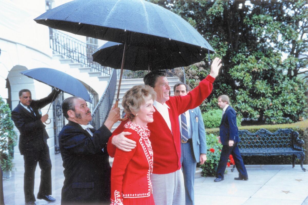 President Reagan and First Lady Nancy Reagan acknowledge supporters after leaving George Washington University Hospital, where the president had been treated after he was shot in 1981.