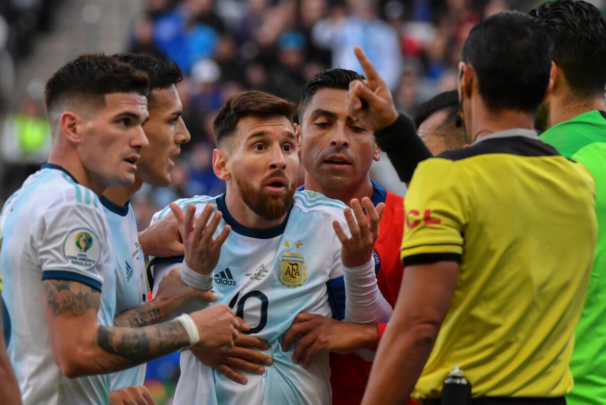 TOPSHOT - Argentina's Lionel Messi (C) talks to Paraguayan referee Mario Diaz de Vivar after he and Chile's Gary Medel (out of frame) were sent off during their Copa America football tournament third-place match at the Corinthians Arena in Sao Paulo, Brazil, on July 6, 2019. (Photo by Nelson ALMEIDA / AFP)NELSON ALMEIDA/AFP/Getty Images ** OUTS - ELSENT, FPG, CM - OUTS * NM, PH, VA if sourced by CT, LA or MoD **