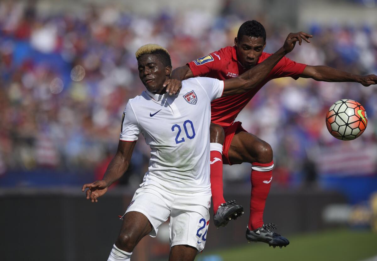 United States midfielder Gyasi Zardes (20) battles for the ball against Cuba defender Yaisnier Napoles, right, during the first half of a CONCACAF Gold Cup quarterfinal match on July 18.