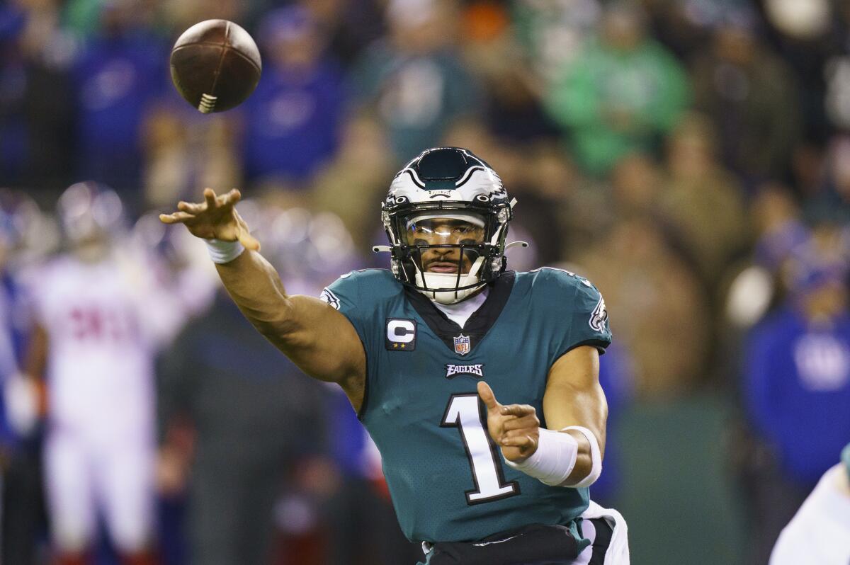 The Eagles' Jalen Hurts throws against the Giants in their playoff game.