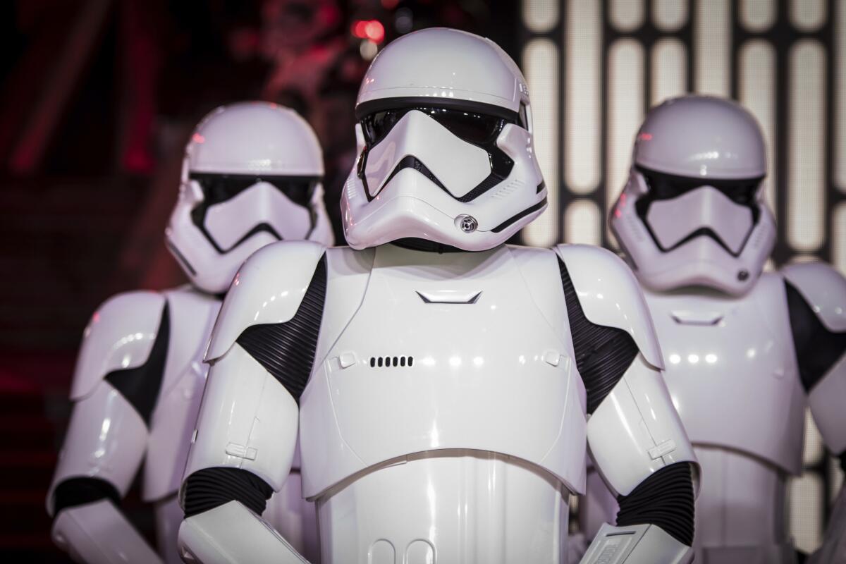 Three people dressed as Stormtroopers in a 'Star Wars' movie