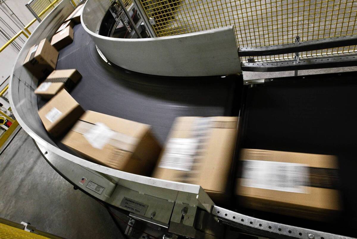 States said they lose more than $23 billion a year in revenue when shoppers buy products online and fail to pay the required sales tax. Above, packages ready to ship move along a conveyor belt at the Amazon.com fulfillment center in Phoenix last year.