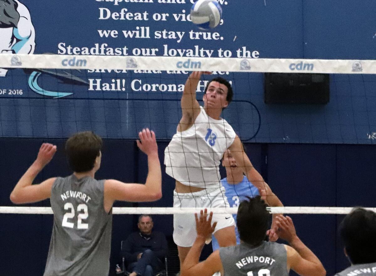 Corona del Mar's Everett Welton (13) hits the ball during Friday's match against rival Newport Harbor.