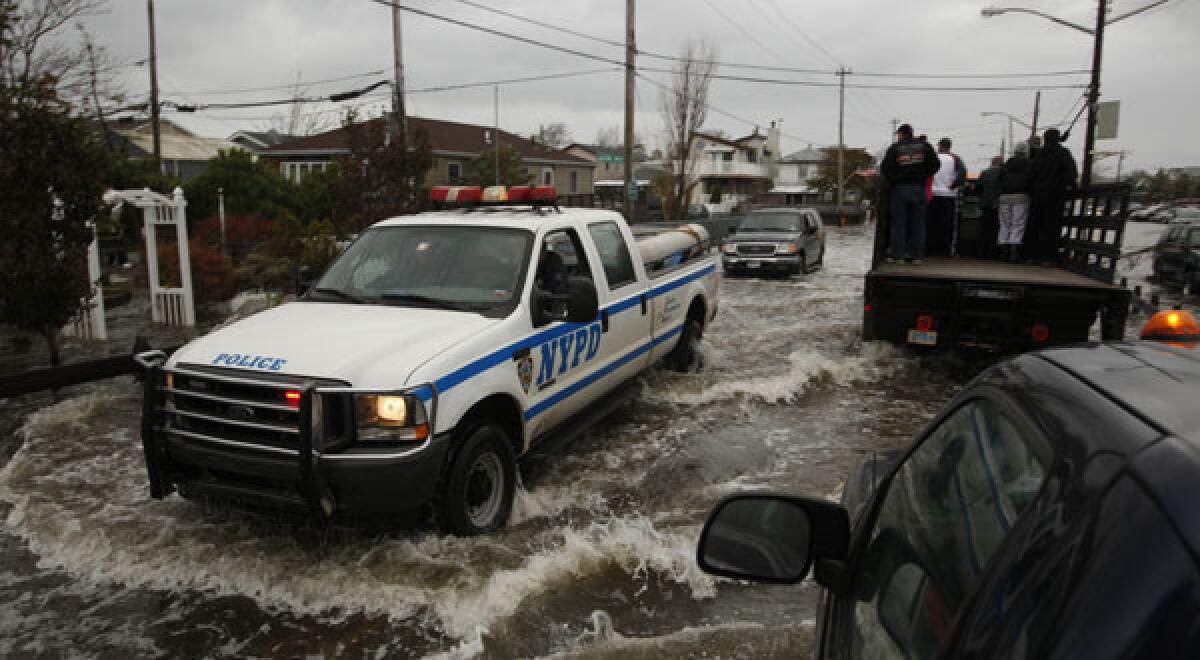 Emergency vehicles in Queens, N.Y., fight through floodwaters to help evacuate residents.