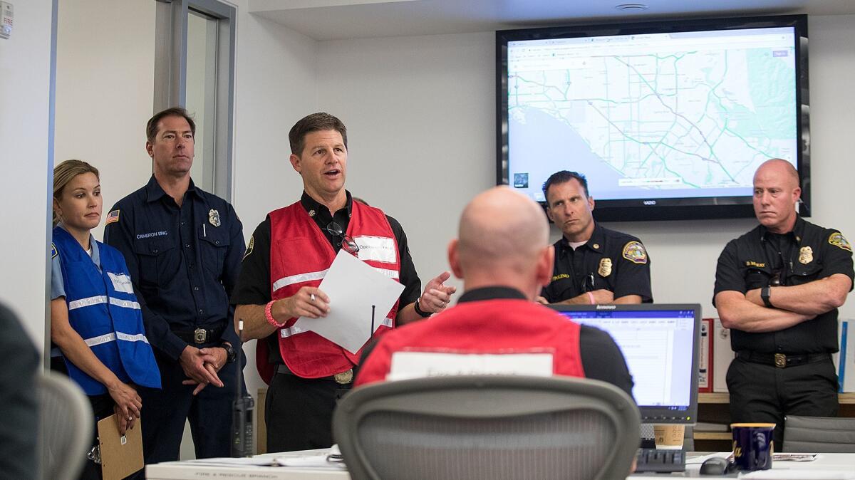 Assistant Fire Chief Jeff Boyles gives a briefing during an emergency response exercise Wednesday at Newport Beach's Emergency Operations Center at the Civic Center.