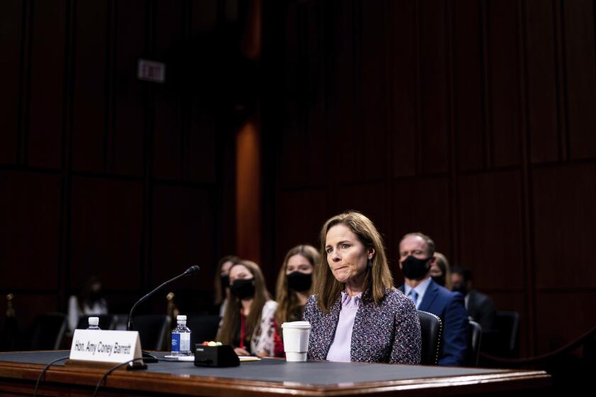 FILE - In this Oct. 14, 2020, file photo, Supreme Court nominee Amy Coney Barrett listens during a confirmation hearing before the Senate Judiciary Committee on Capitol Hill in Washington. Barrett served for nearly three years on the board of a private Christian school that effectively barred admission to children of same-sex parents and made it plain openly gay and lesbian teachers weren’t welcome in the classroom. (Erin Schaff/The New York Times via AP, Pool, File)