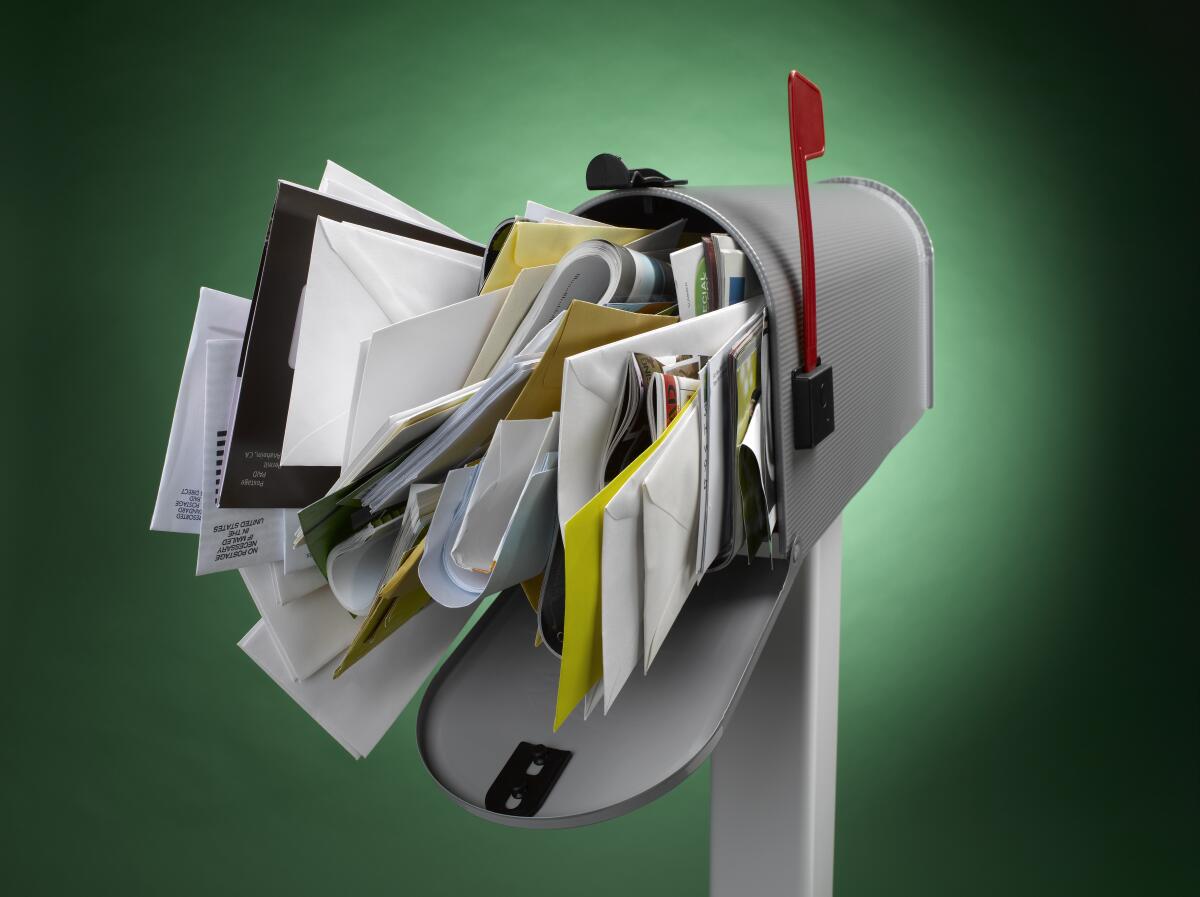 Illustration shows a mailbox stuffed with mail
