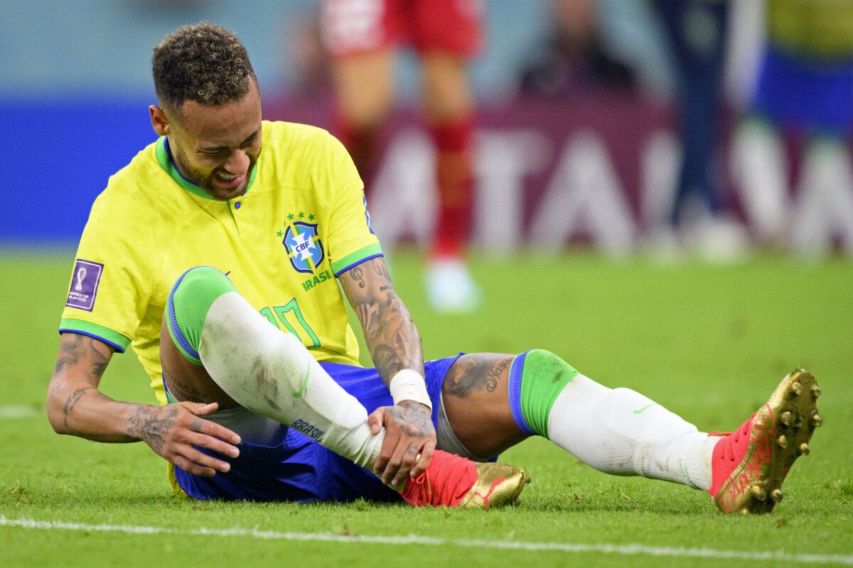 Brazil's Neymar grabs his ankle after an injury during the World Cup 
