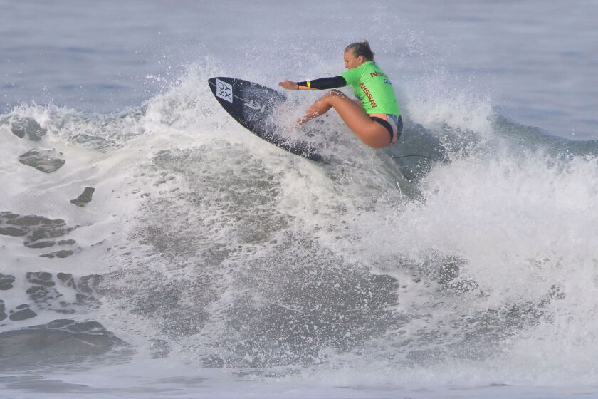 Savannah Stone of Hawaii competes on the first day of the Super Girl Surf Pro competition on Friday at the Oceanside Pier. She won the heat to advance. The event continues through Sunday.  