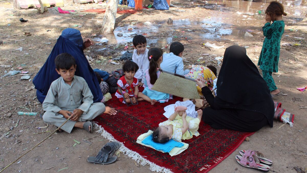 Afghan refugees wait at a United Nations center in Peshawar, Pakistan, on Aug. 18 before traveling to Afghanistan.