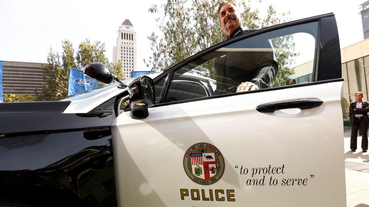 Mayor Eric Garcetti's budget will divert funds away from neighborhood police patrols, the Los Angeles Police Protective League says. Above, LAPD Chief Charlie Beck with a new hybrid police car earlier this month.