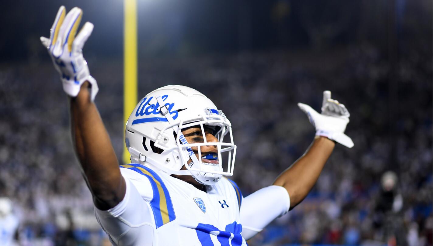 -UCLA receiver Austin Roberts celebrates his touchdown catch against Colorado in the 1st quarter.