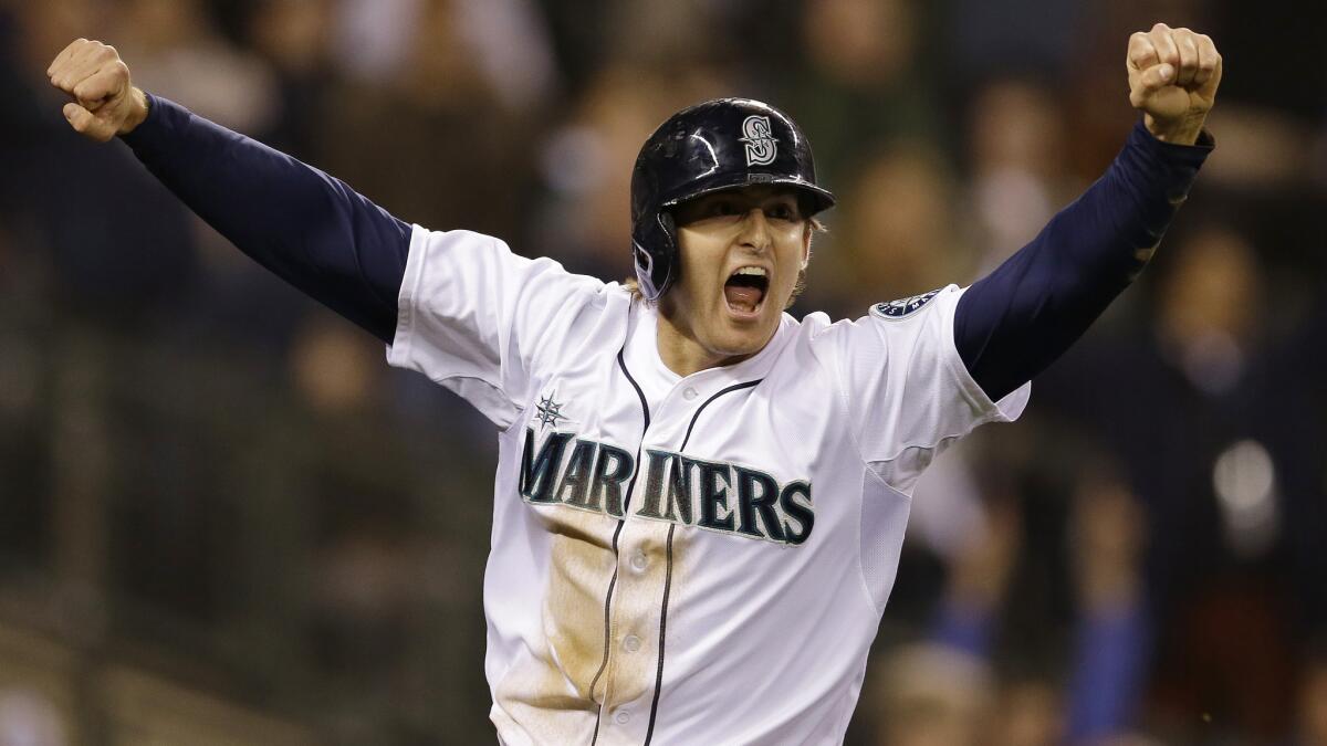 Seattle's Brad Miller celebrates after scoring the winning run in the 11th inning of a 2-1 victory over the Angels on Saturday.
