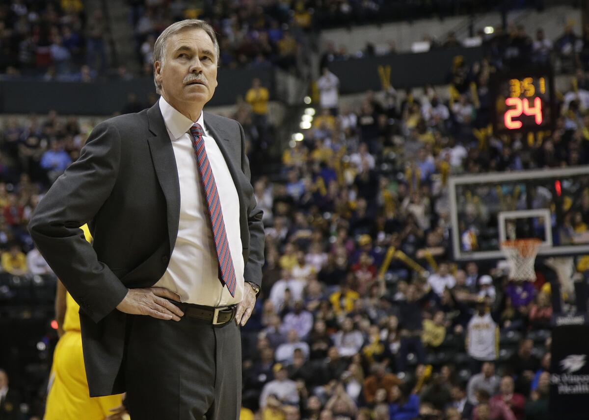Lakers Coach Mike D'Antoni checks the scoreboard during a 118-98 loss to the Pacers on Tuesday night in Indianapolis.