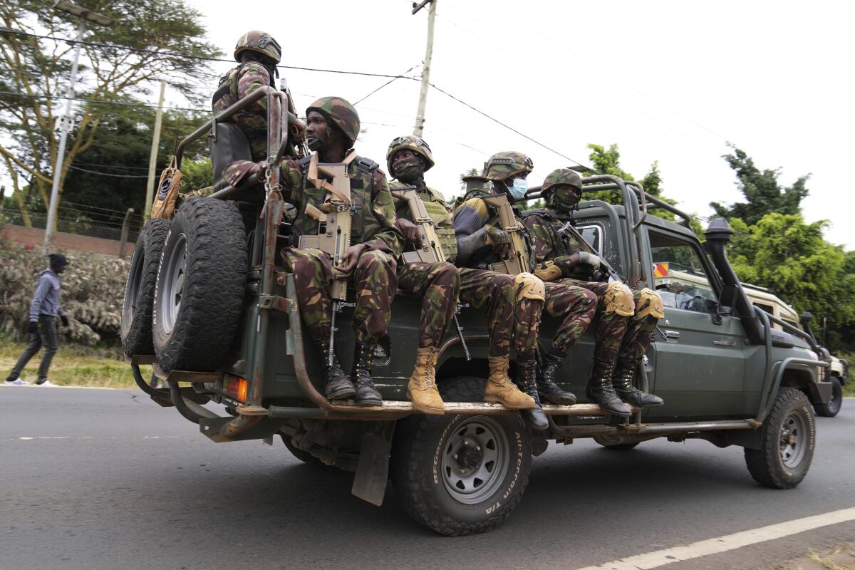 Kenya army soldiers patrol on a truck.