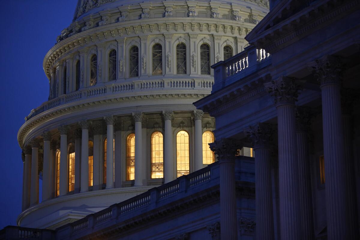 Lights are on at dusk inside the U.S. Capitol dome.