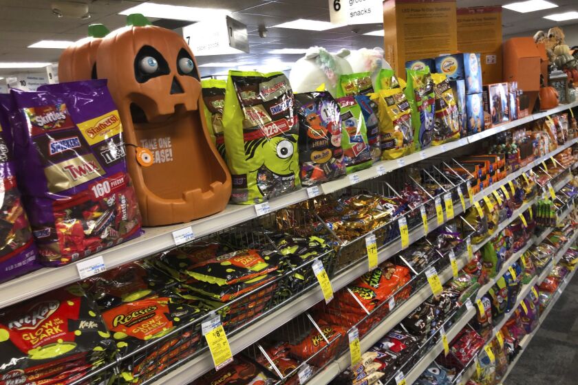 Halloween candy and decorations are displayed at a store, Wednesday, Sept. 23, 2020, in Freeport, Maine. U.S. sales of In this year of the pandemic, with trick-or-treating still an uncertainty, Halloween candy were up 13% over last year in the month ending Sept. 6, according to data from market research firm IRI and the National Confectioners Association. (AP Photo/Robert F. Bukaty)