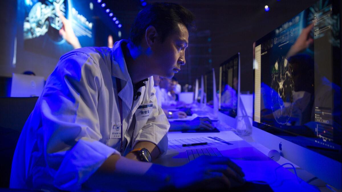 A doctor examines an image during the CHAIN Cup, the world's first competition in neuroimaging between AI and human experts, in Beijing on June 30, 2018.