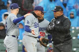 CHICAGO, ILLINOIS - APRIL 07: Miguel Rojas #11 of the Los Angeles Dodgers argues.