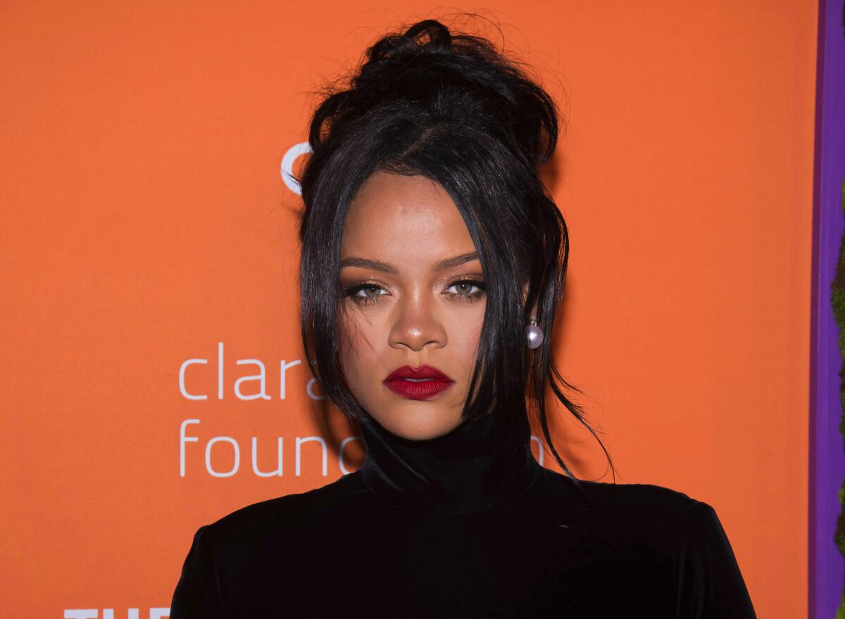 A woman in a black turtleneck attends an event