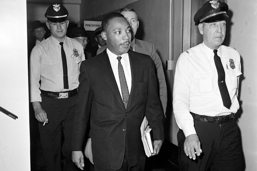 FILE - In this Oct. 25, 1960 file photo, Dr. Martin Luther King Jr. leaves court after being given a four-month sentence in Decatur, Ga., for taking part in a lunch counter sit-in at Rich's department store. Following the publication of "An Appeal for Human Rights" on March 9, 1960, students at Atlanta's historically black colleges waged a nonviolent campaign of boycotts and sit-ins protesting segregation at restaurants, theaters, parks and government buildings. (AP Photo, File)