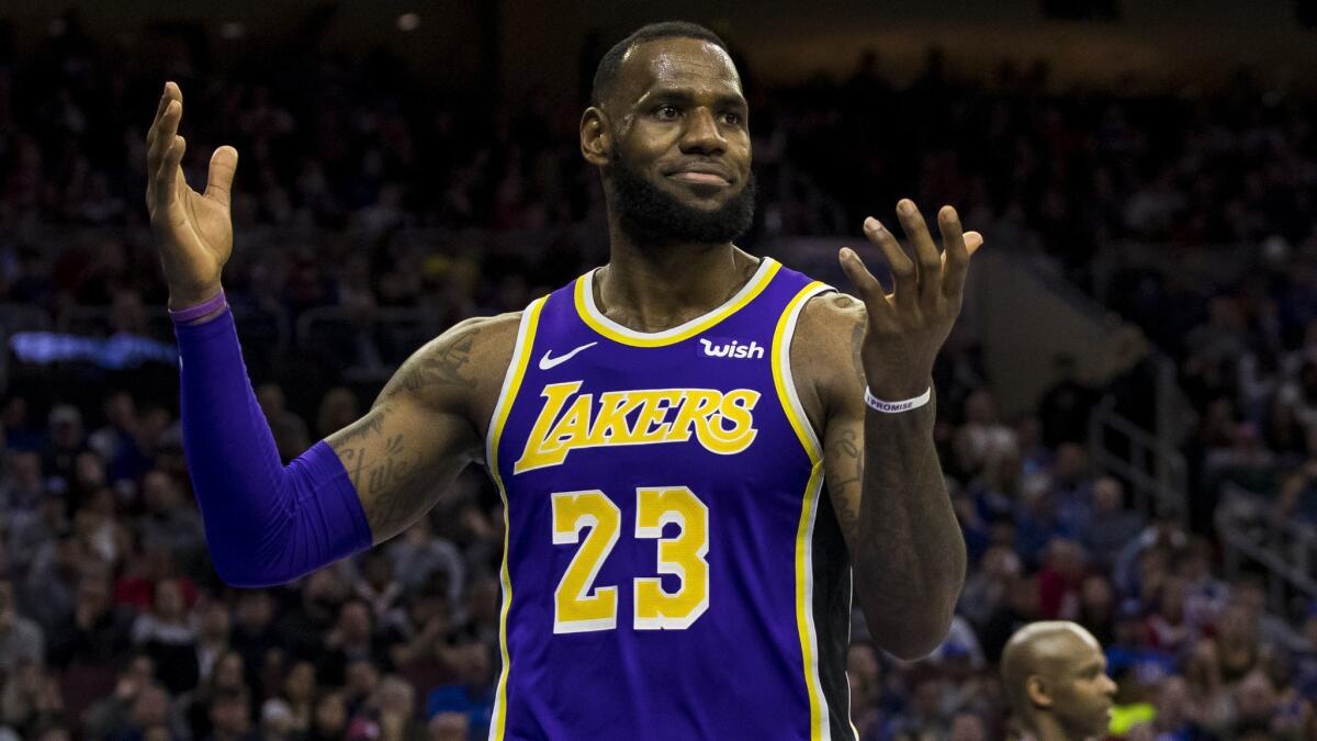 Lakers star LeBron James reacts to a play during the second half of a 143-120 loss to the Philadelphia 76ers on Sunday.