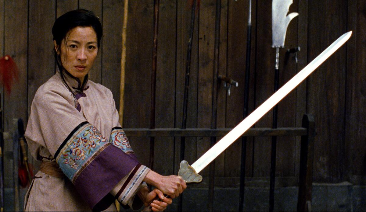 A woman warrior wields a sword.
