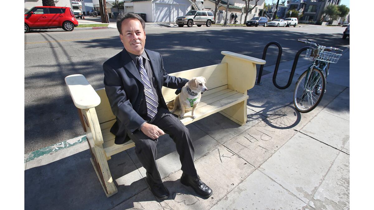 Cat detective Jack Tyler and his search dog, Daphne, outside his "office," the Sit Stop Cafe, in Huntington Beach on Tuesday.