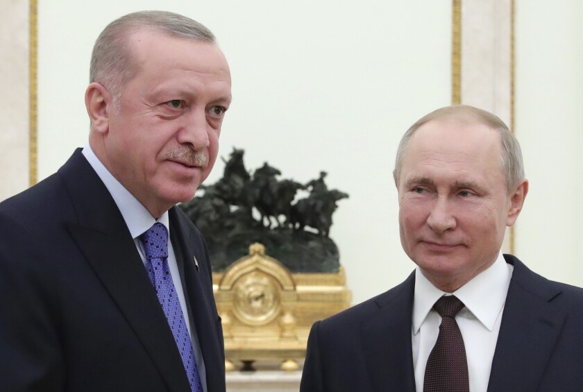 Russian President Vladimir Putin, right, and Turkish President Recep Tayyip Erdogan are imposing more controls on free expression in response to the coronavirus crisis.
