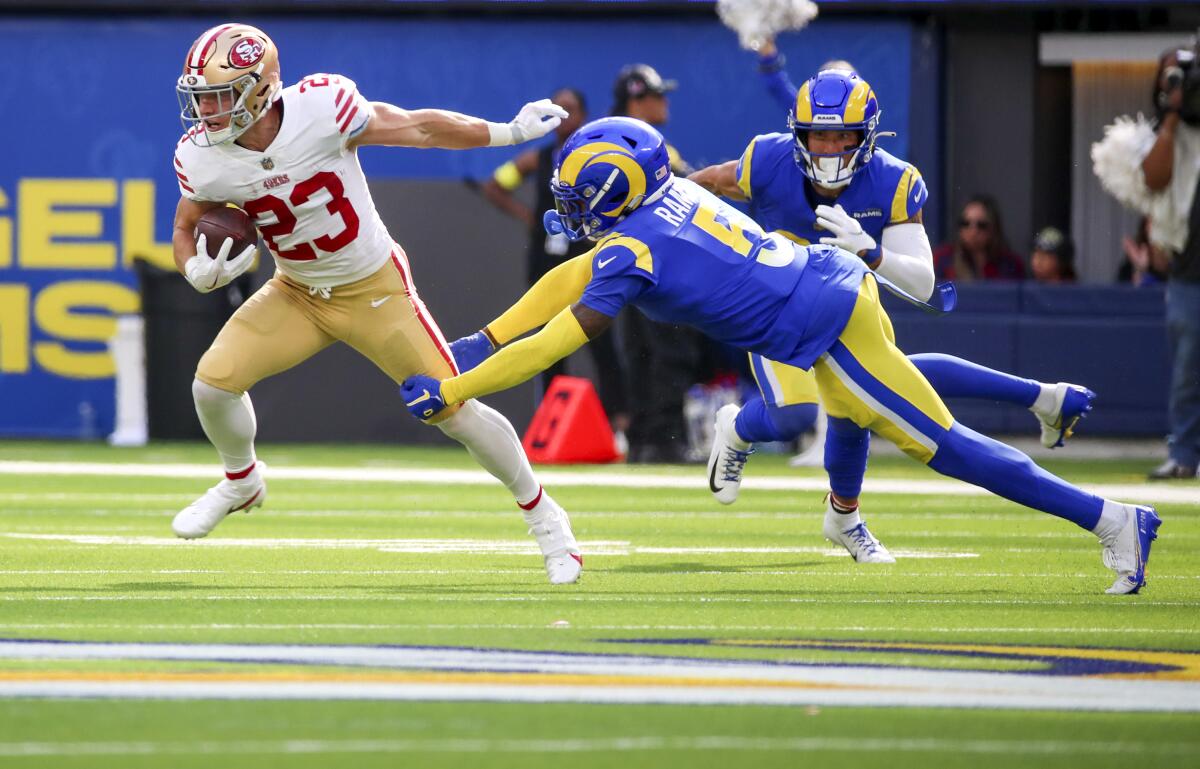 Christian McCaffrey rushes past Jalen Ramsey in the second quarter.