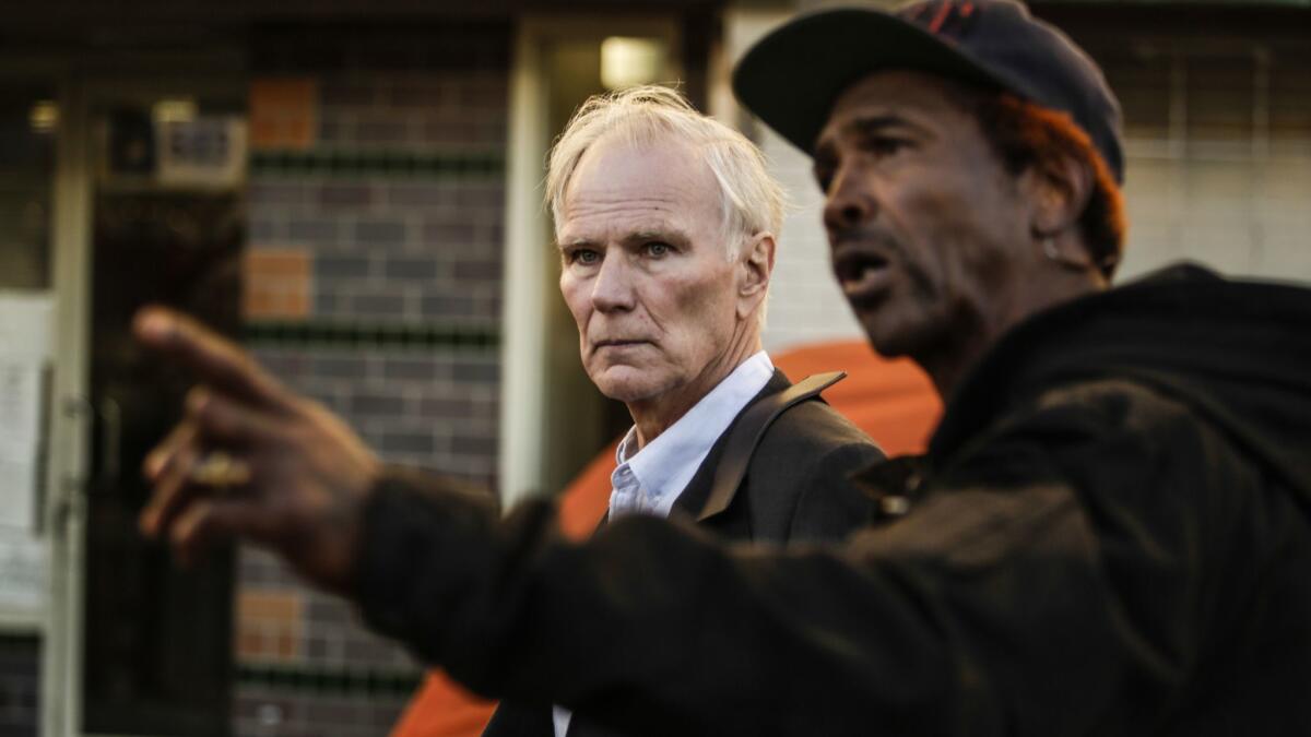 U.N. special rapporteur Philip Alston gets a tour of skid row in downtown Los Angeles with General Dogon on Dec. 5, 2017.