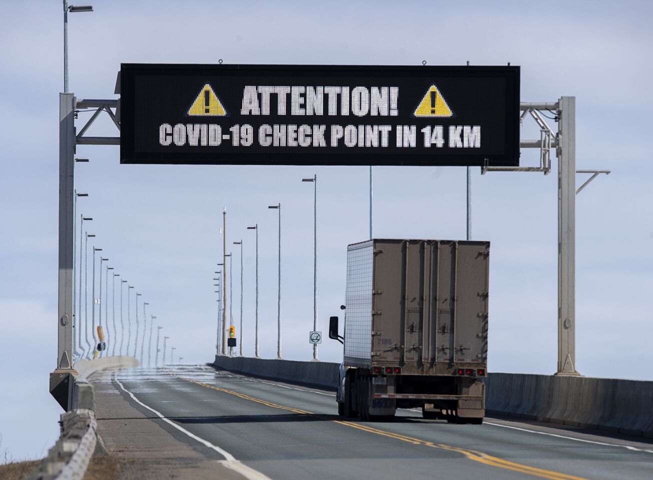 Canada: A sign indicates that provincial health department workers will stop traffic that has crossed the Confederation Bridge in Cape Jourimain, New Brunswick, Canada.