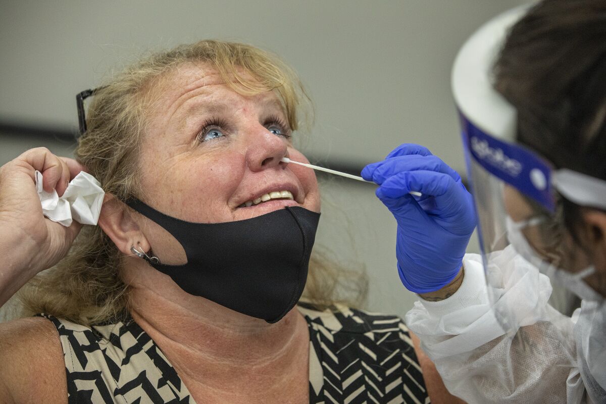 Agoura High School employee Laurie Goldfinger is given a COVID-19 test.