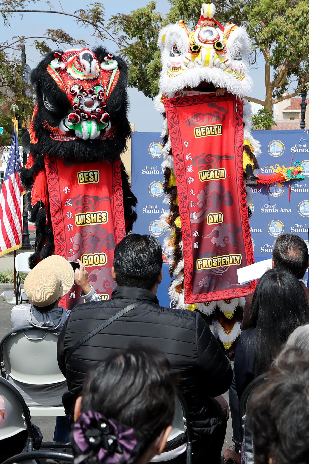 Guests watch a lion dance performance during a ceremony marking the signing of an official Chinatown apology.