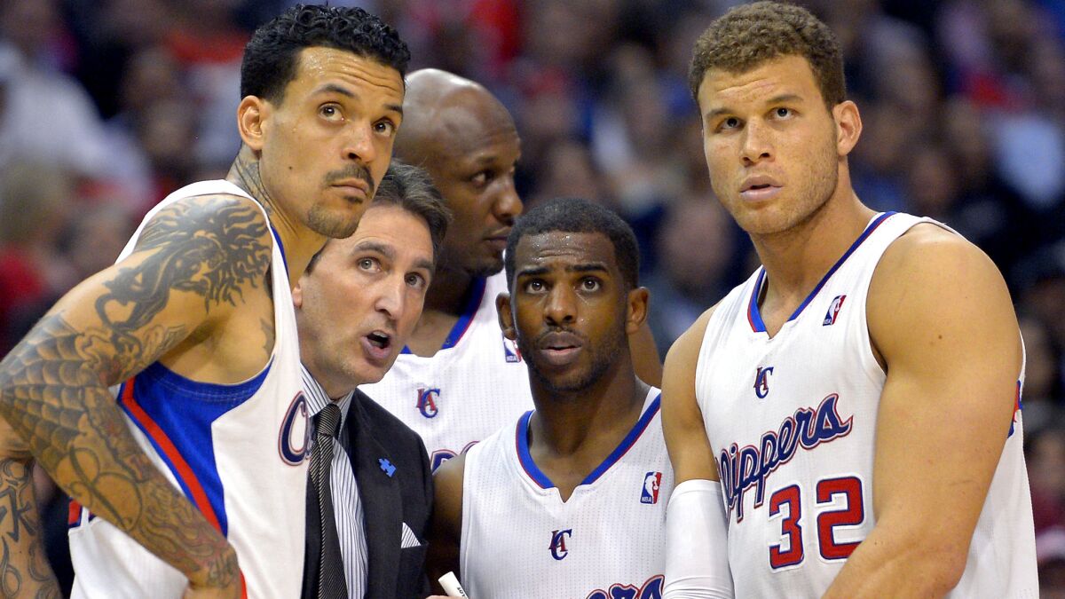 Lamar Odom, rear center, was part of the 2012-13 Clippers team along with, from left, Matt Barnes, Coach Vinny Del Negro, Chris Paul and Blake Griffin.