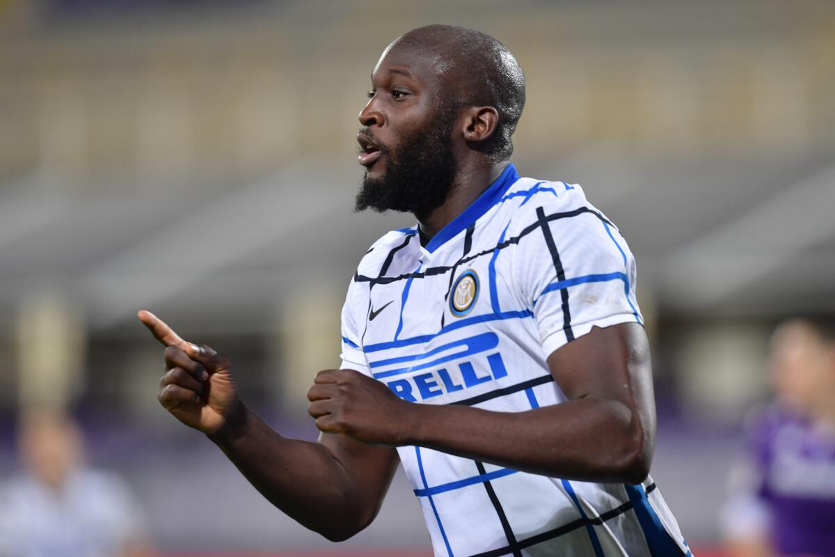 Inter's Romelu Lukaku celebrates after scoring his side's second and decisive goal during the Italian Cup round of 16 soccer match between Fiorentina and Inter Milan, at the Artemio Franchi stadium in Florence, Italy, Wednesday, Jan. 13, 2021. (Jennifer Lorenzini/LaPresse via AP)