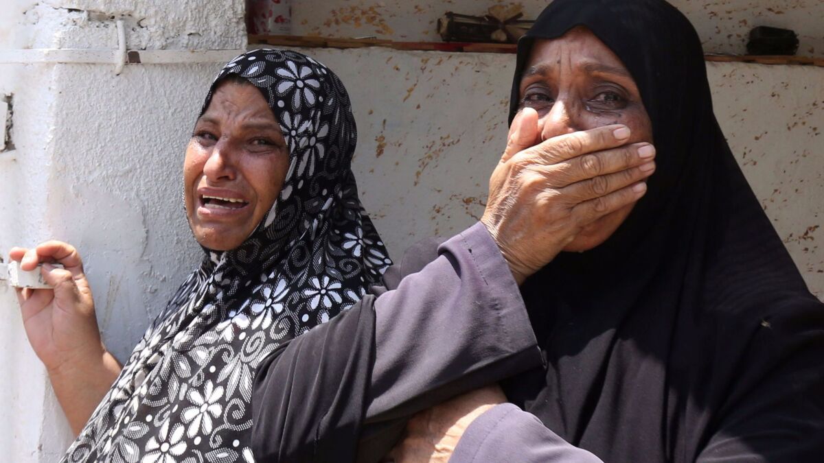 Relatives of 17-year-old Mohammed Jawawdeh, who was killed when he attacked a security guard at the Israeli Embassy compound in the Jordanian capital, Amman, cry during his funeral on July 25, 2017, in Amman.
