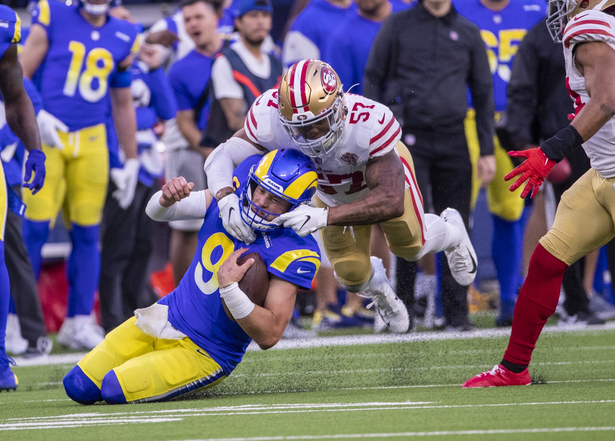 San Francisco outside linebacker Dre Greenlaw tackles Rams quarterback Matthew Stafford.