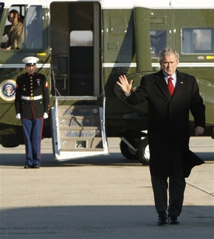 President George W. Bush waves as he walks at Andrews Air Force Base in Maryland, Tuesday, Nov. 25, 2008, prior to boarding Air Force One for a day trip to Kentucky. (AP Photo/Gerald Herbert)