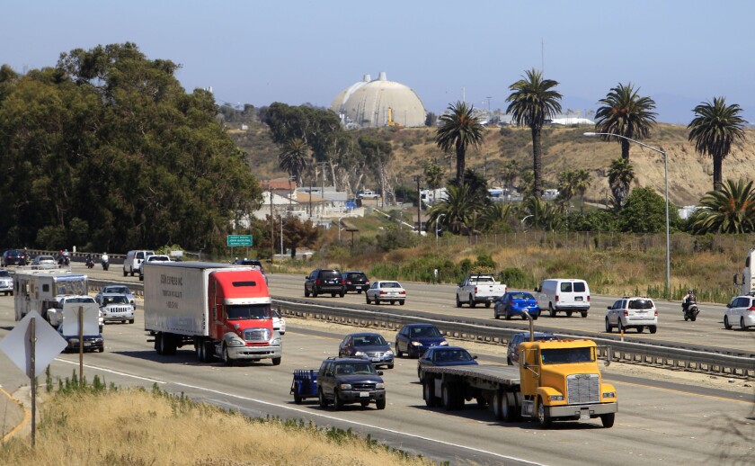 A steady flow of traffic on Interstate 5 runs past the San Onofre Nuclear Generating Station in San Clemente. The Los Angeles City Council called on federal regulators to take more time before making a decision on the plant's fate.