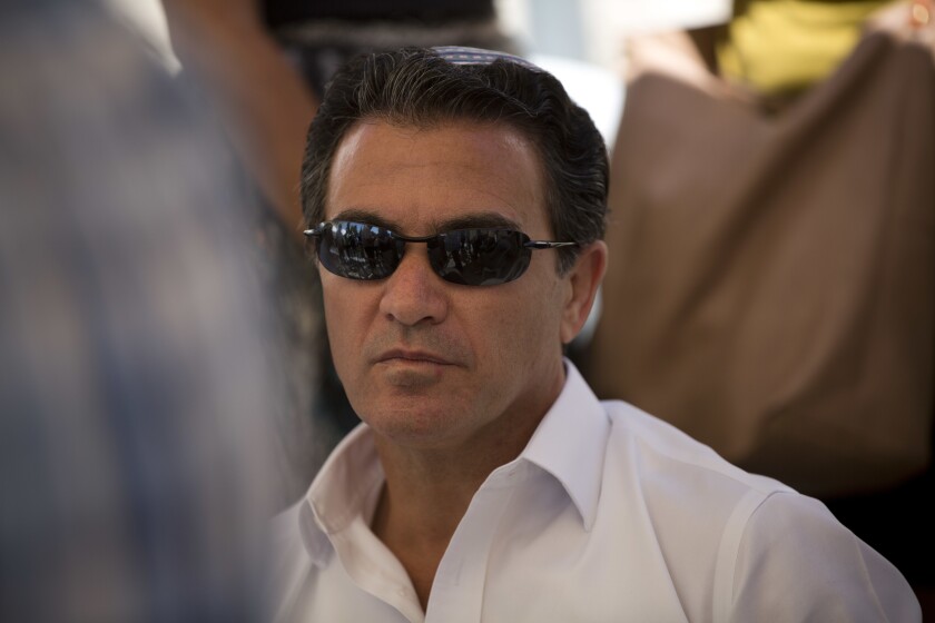 FILE - In this July 3, 2016, file photo, Yossi Cohen, then the director of Israel's Mossad intelligence agency, attends the funeral in Jerusalem of a rabbi killed by Palestinian gunmen. Cohen, the outgoing chief of Israel's Mossad intelligence service, offered the closest acknowledgment yet his country was behind a series of recent attacks targeting Iran's nuclear program and a military scientist in a television interview aired Thursday, June 10, 2021. (AP Photo/Oded Balilty, File)