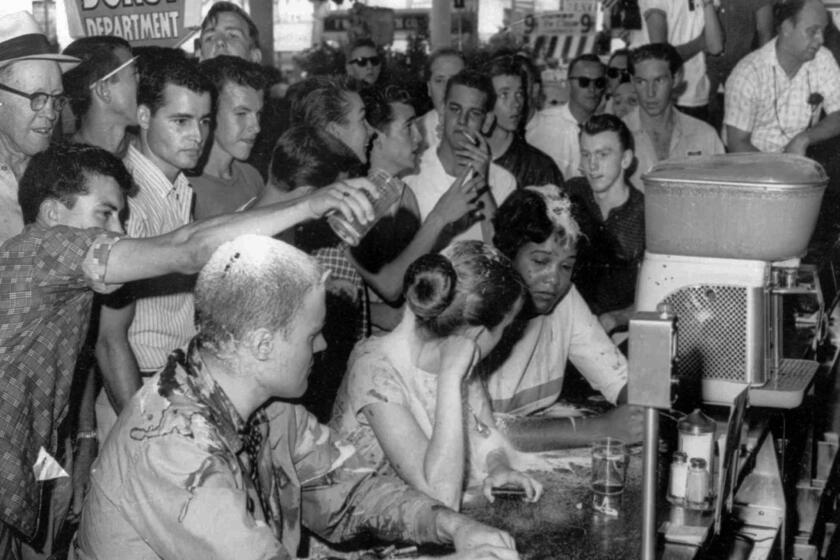 A May 28, 1963, sit-in demonstration at a Woolworth's lunch counter in Jackson, Miss., turned violent when whites poured sugar, ketchup and mustard over the heads of demonstrators, from left, John Salter, Joan Trumpauer and Anne Moody.