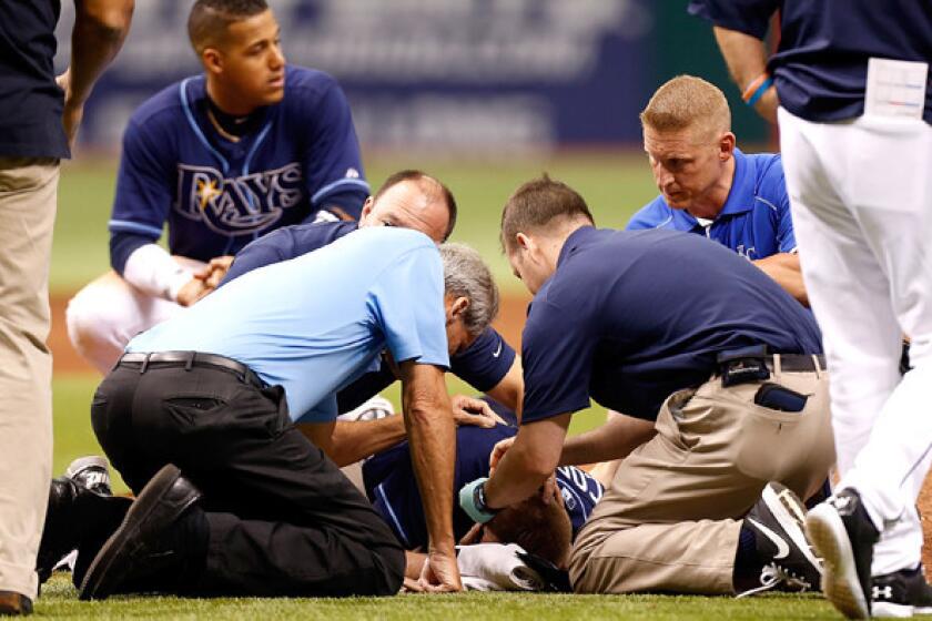 Medical staffers tend to Rays pitcher Alex Cobb after he was hit in the head by a line drive during a game against the Royals on Saturday.