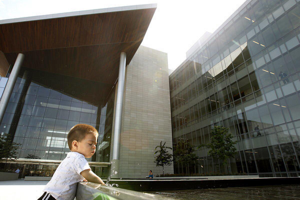 Issac Hernandez, 16 months, plays in a fountain at the new Gov. George Deukmejian Courthouse in Long Beach.