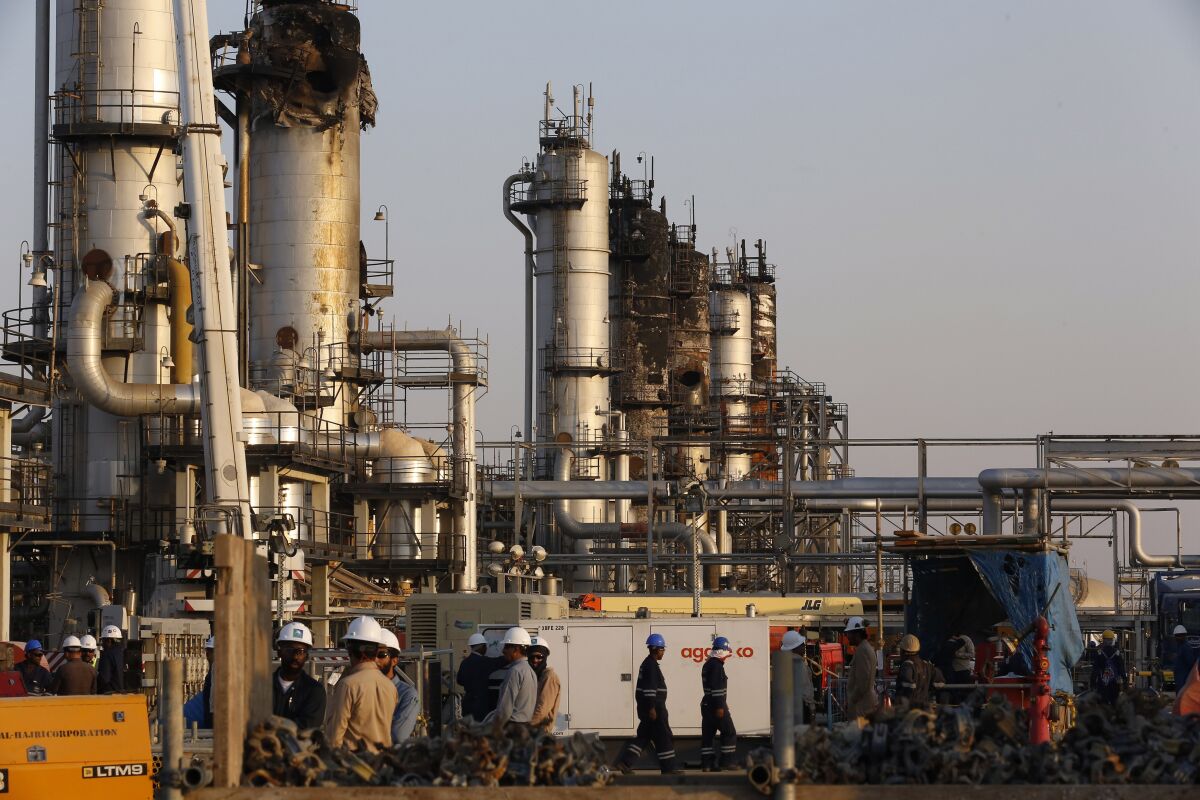 In this Sept. 20, 2019, file photo, taken during a trip organized by Saudi information ministry, workers fix the damage in Aramco's oil separator at processing facility after the recent Sept. 14 attack in Abqaiq, near Dammam in the Kingdom's Eastern Province.