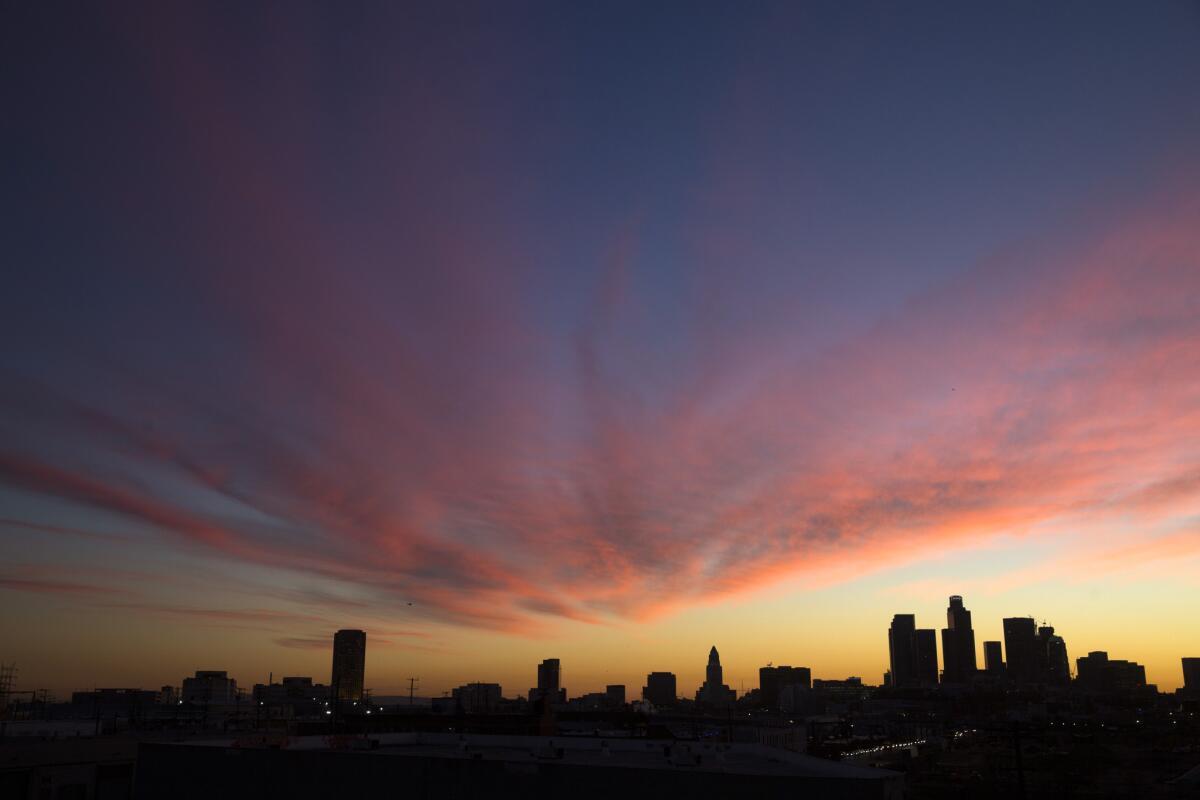High clouds drift over the downtown LA skyline on a balmy evening in Los Angeles, Calif., on Jan. 28, 2016.