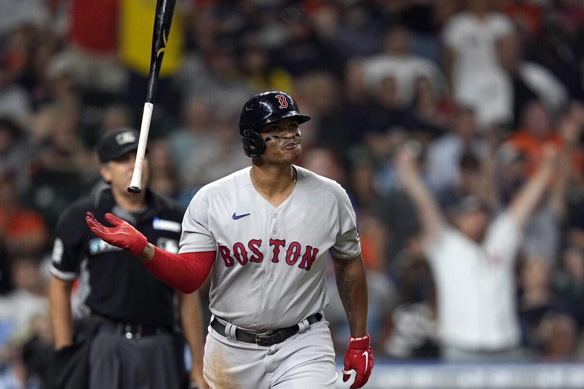 Boston Red Sox's Rafael Devers flips his bat after hitting a home run against the Houston Astros during the sixth inning of a baseball game Tuesday, Aug. 2, 2022, in Houston. (AP Photo/David J. Phillip)
