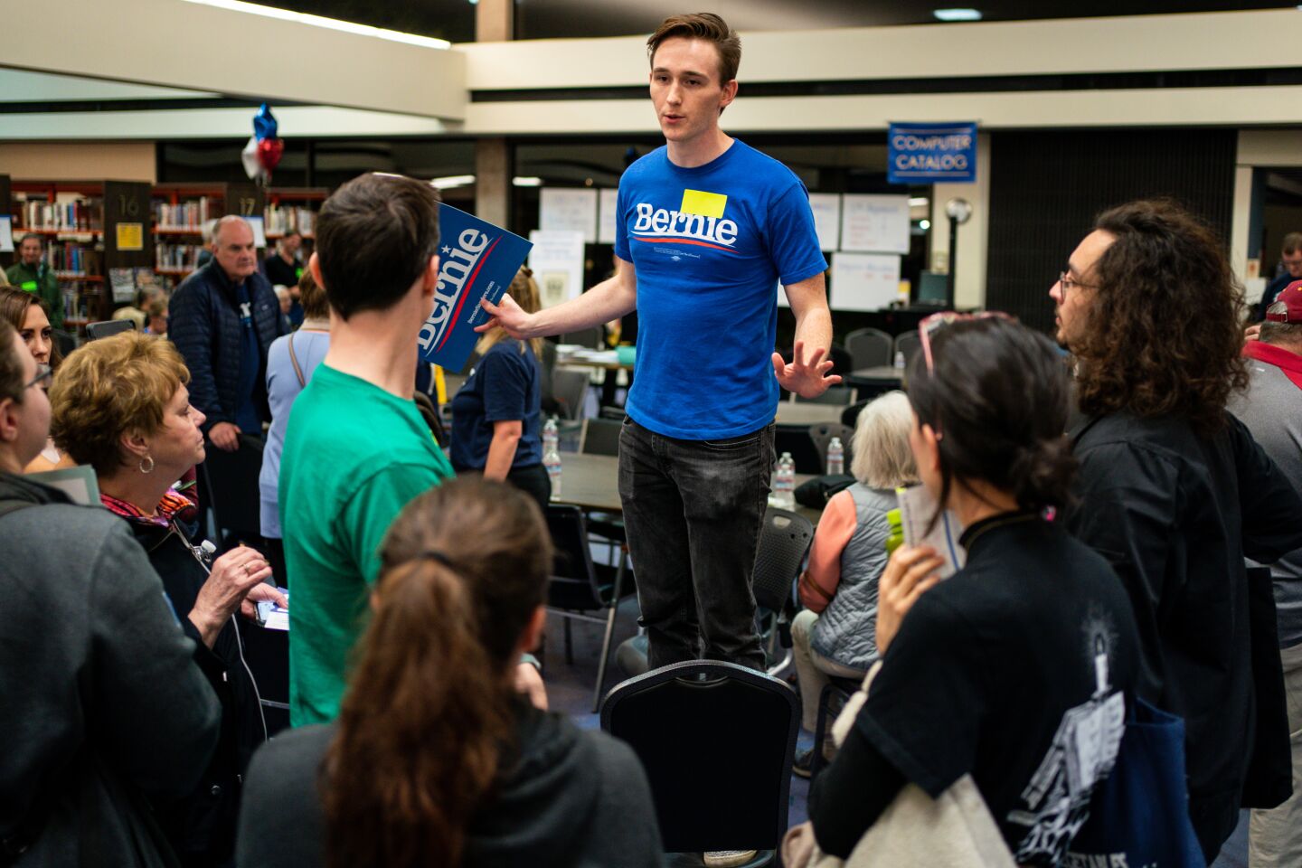 Trevor McMahan of Orange City, Iowa, addresses supporting caucusgoers for Sens. Bernie Sanders and Elizabeth Warren during a satellite caucus at the Palm Springs Public Library on Monday in Palm Springs.